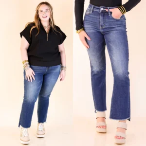 A fashionable young woman in Judy Blue Jeans and a beige tank top walking confidently outdoors on a sunny day.

