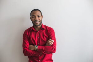 A man wearing the red colored mens shirts