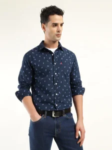 Man wearing a navy blue printed full- mens shirts paired with blue jeans.

