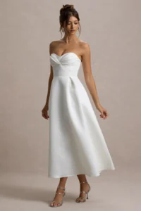a woman having white midi dress showing it's alegance